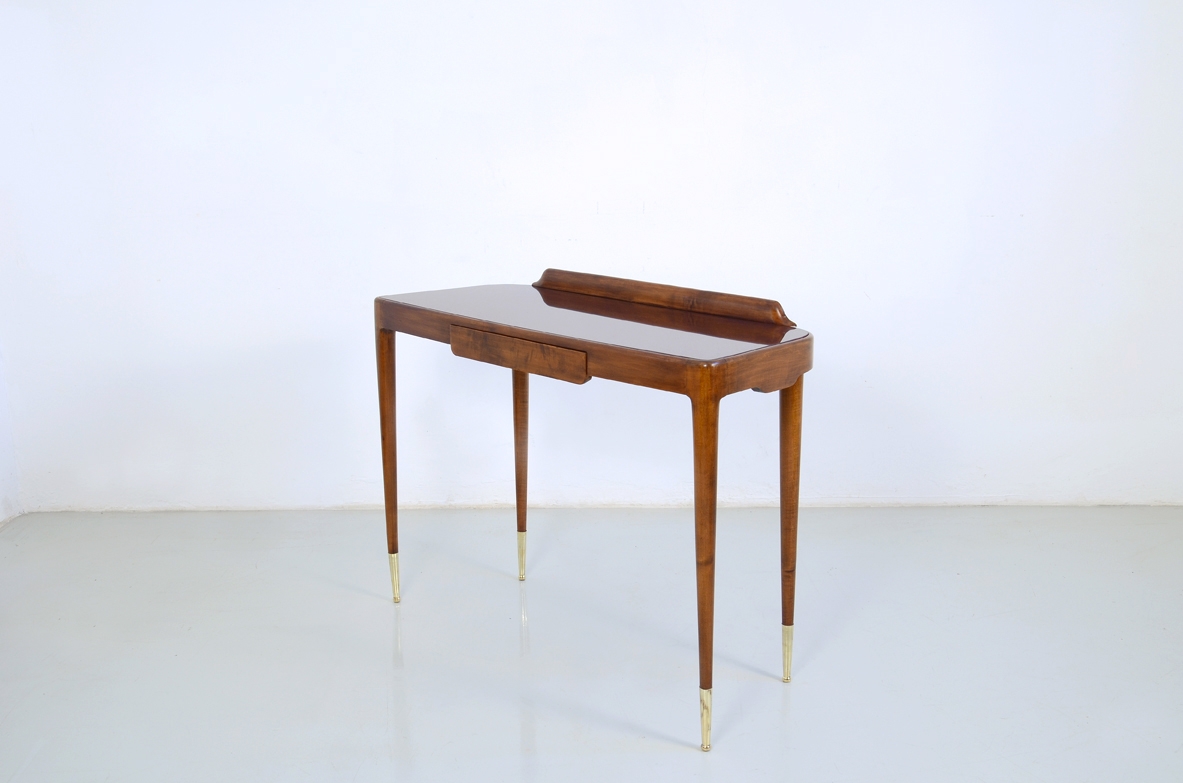 Elegante console con sottili gambe tornite e lunghi puntali in ottone, piano in opaline rosso scuro. Italia 1950ca.