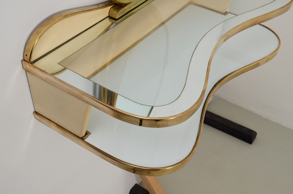 Gio Ponti, rare hanging console table in lacquered wood and brass with two shelves, one in mirrored glass and one in white opaline. Adjustable oval mirror on top. Provenience Cellina/Bormioli private collection. Gio Ponti Archive ref. Nr 16089.