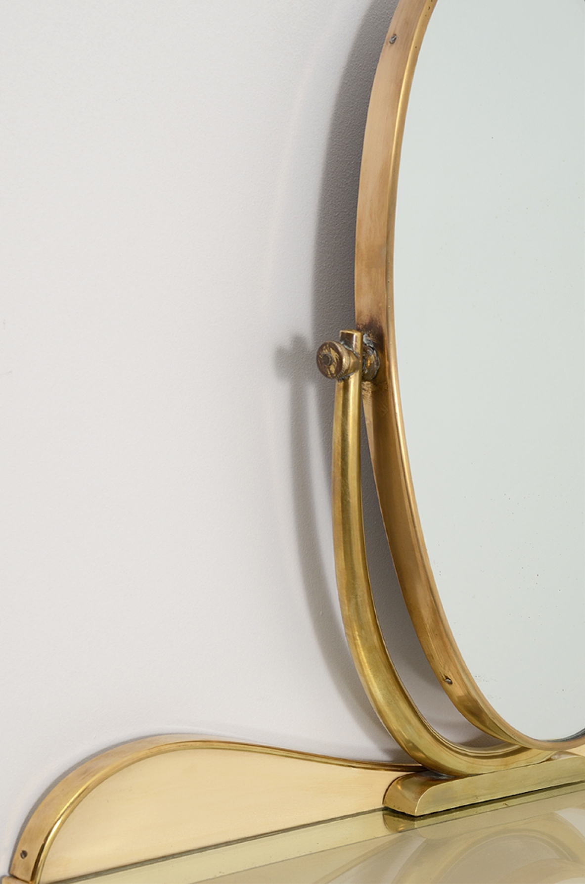 Gio Ponti, rare hanging console table in lacquered wood and brass with two shelves, one in mirrored glass and one in white opaline. Adjustable oval mirror on top. Provenience Cellina/Bormioli private collection. Gio Ponti Archive ref. Nr 16089.