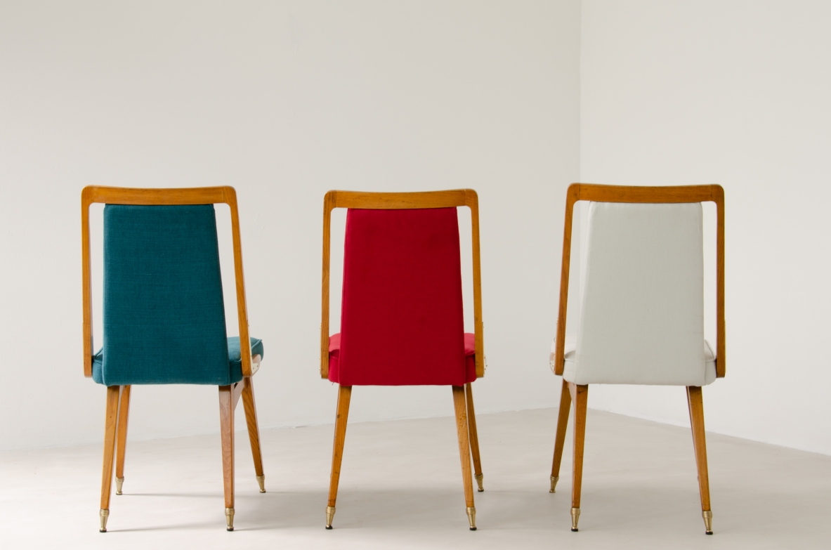 Set of 8 beautiful 1950's Italian chiars in light oak wood with refined brass tips and details. Upholstery on seat and back.