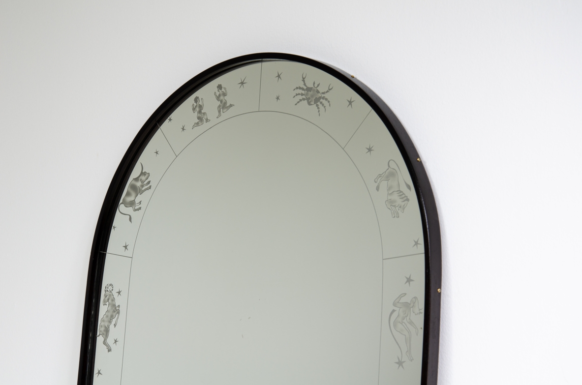 Mirror with engravings depicting the signs of the zodiac.  Mirrored crystal with stained wood frame.  Italy, 1940's.