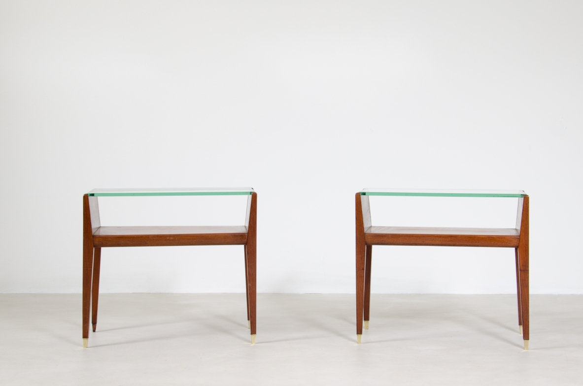 Coppia di comodini in legno con piano in cristallo e puntali in ottone. Manifattura italiana, 1950ca.