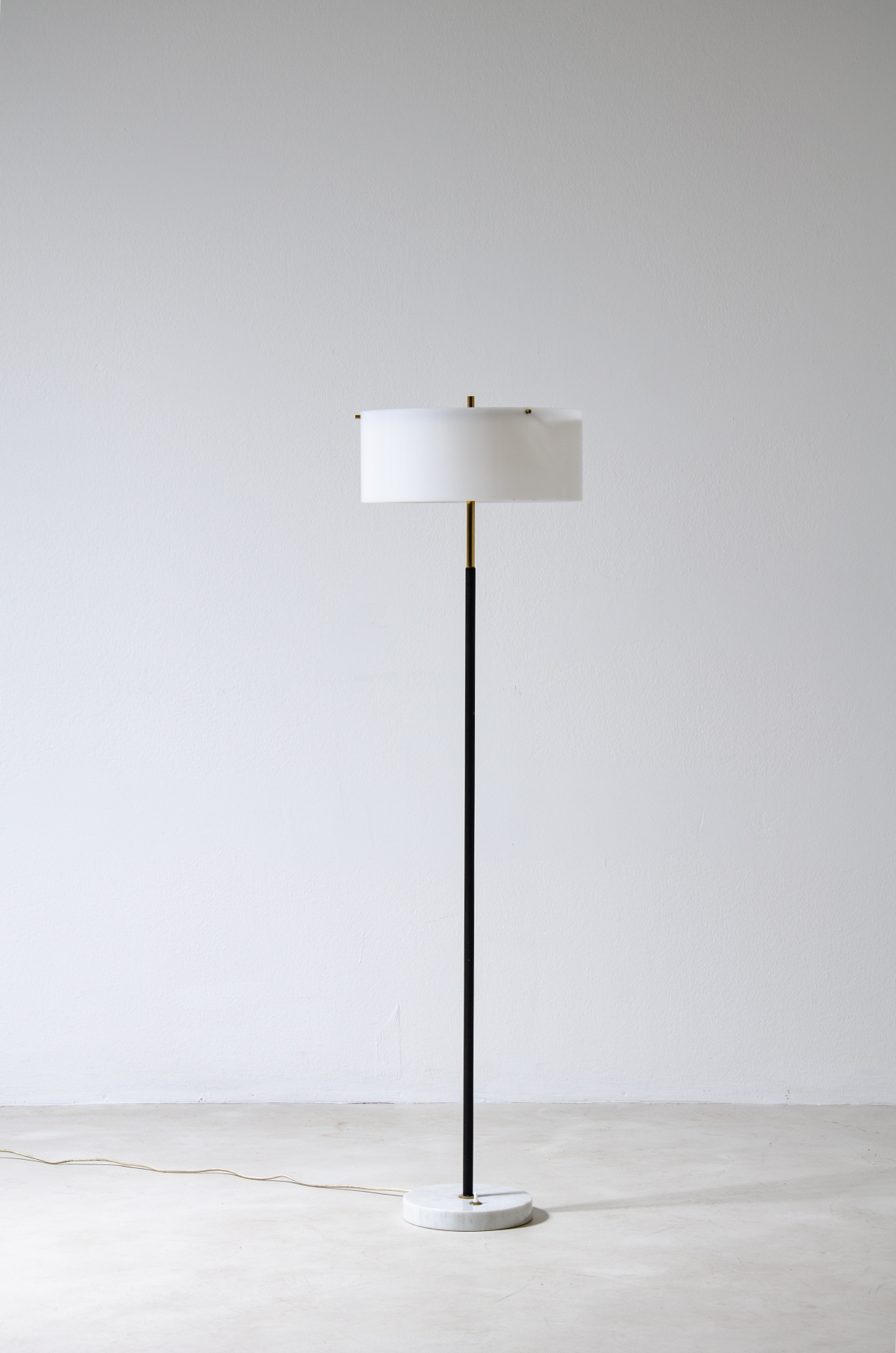 Tito Agnoli, metal and brass floor lamp with marble base and black and white methacrylate hat.  Produced by Oluce 1955.