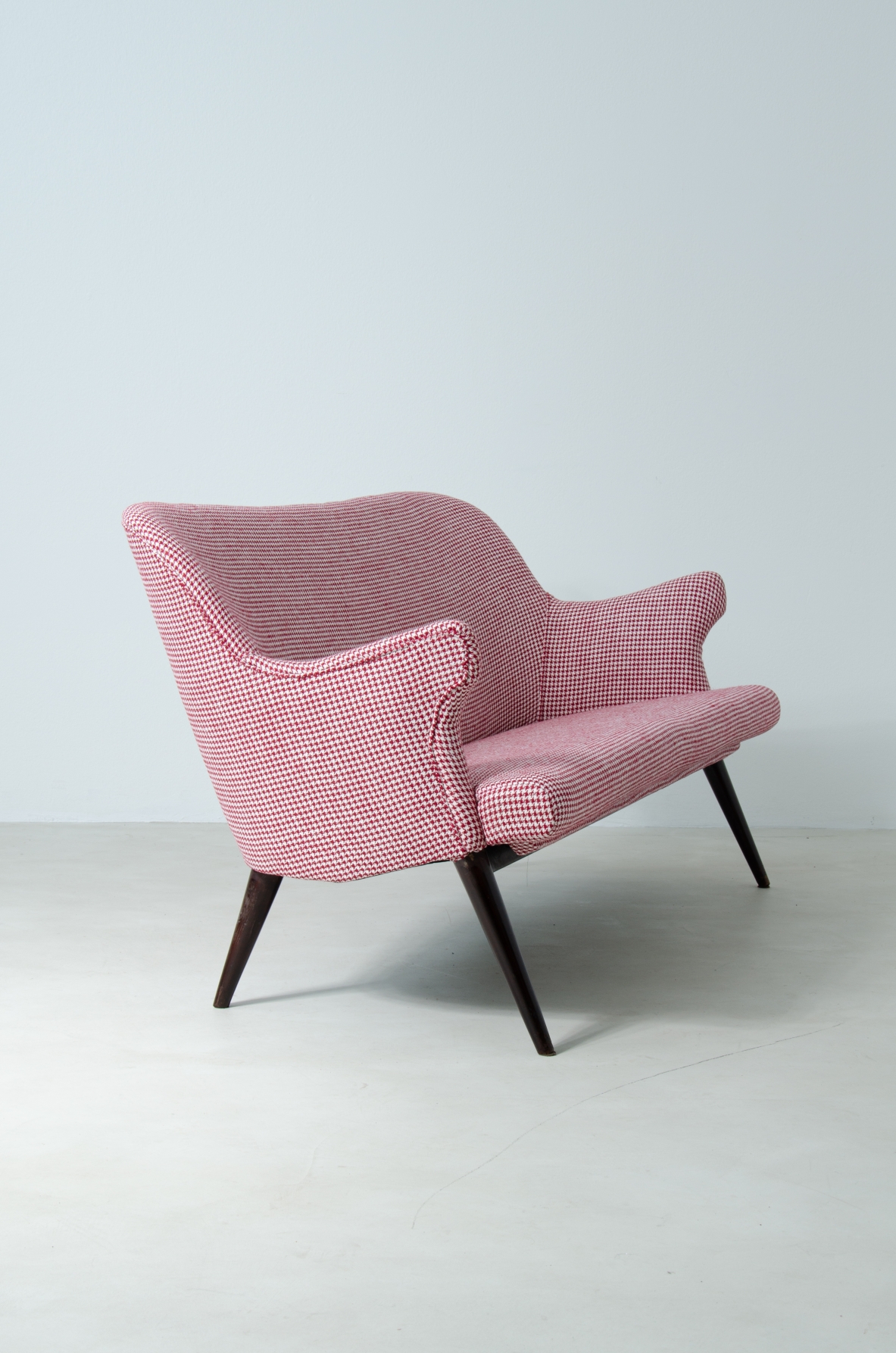 Osvaldo Borsani (1911-1985)  Sofa covered in fabric with long turned wooden feet.  Manifactured by ABV.  Borsani, Varedo, 1950s.