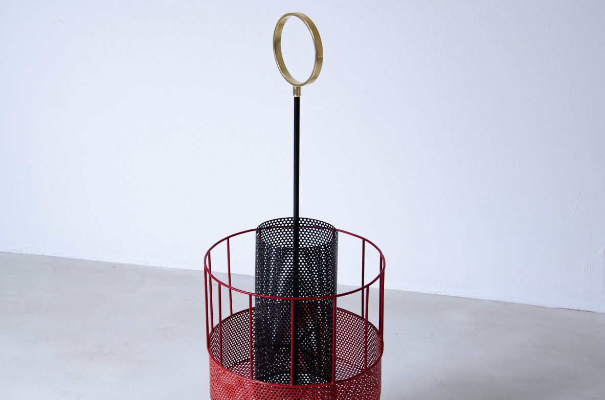 Mathieu Matègot, perforated and colored metal magazine rack or bottle holder with enamelled iron handle and foot.  French 1950s manufacture.