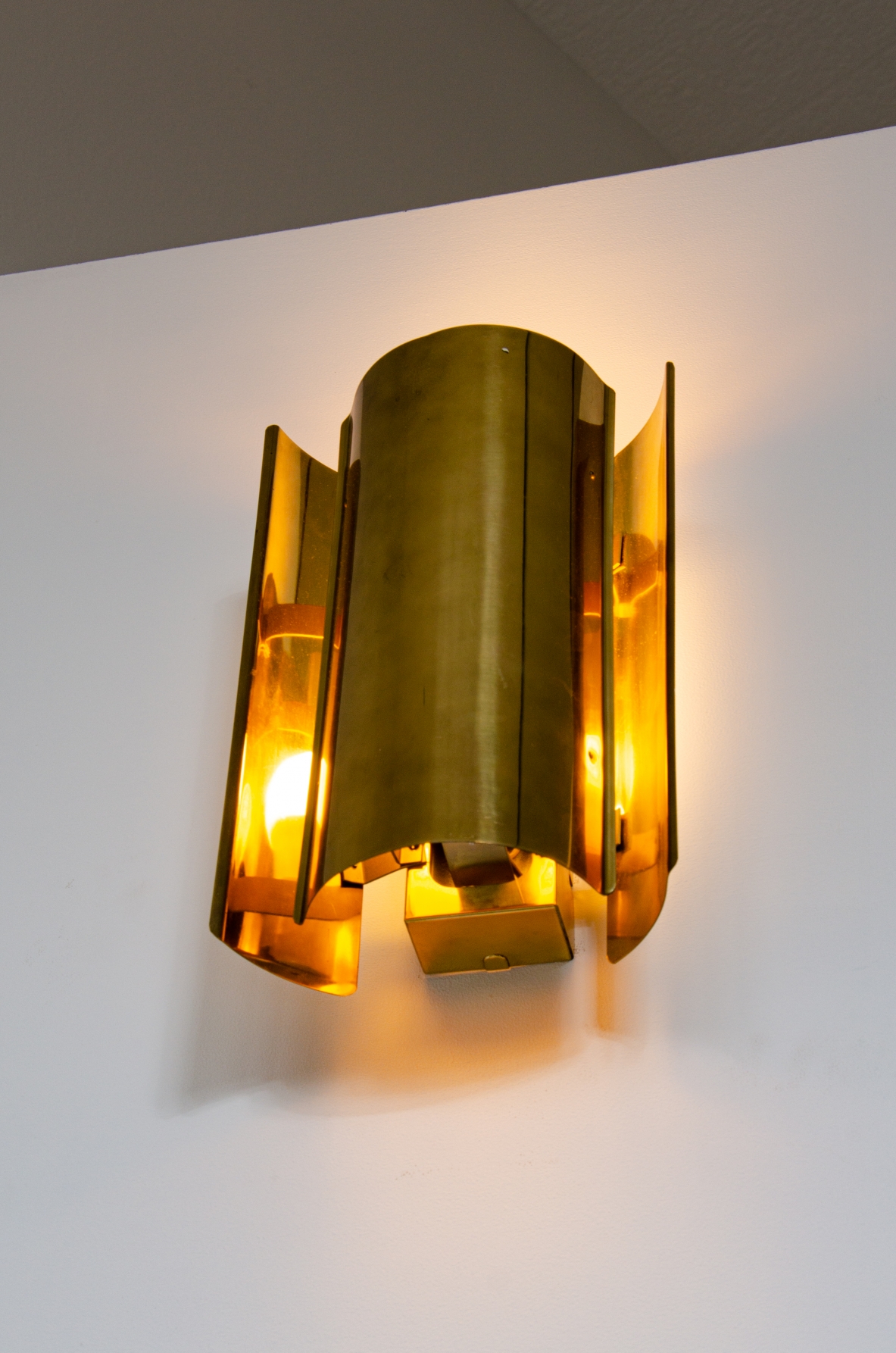 Pair of sconce wall lights in curved brass.  Prod. Falkenbergs, Sweden 1960's.