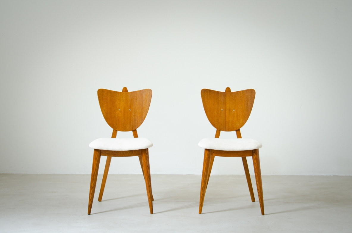 Two oak chairs with padded wooden seat and heart-shaped back.  French manufacture, 1950's.
