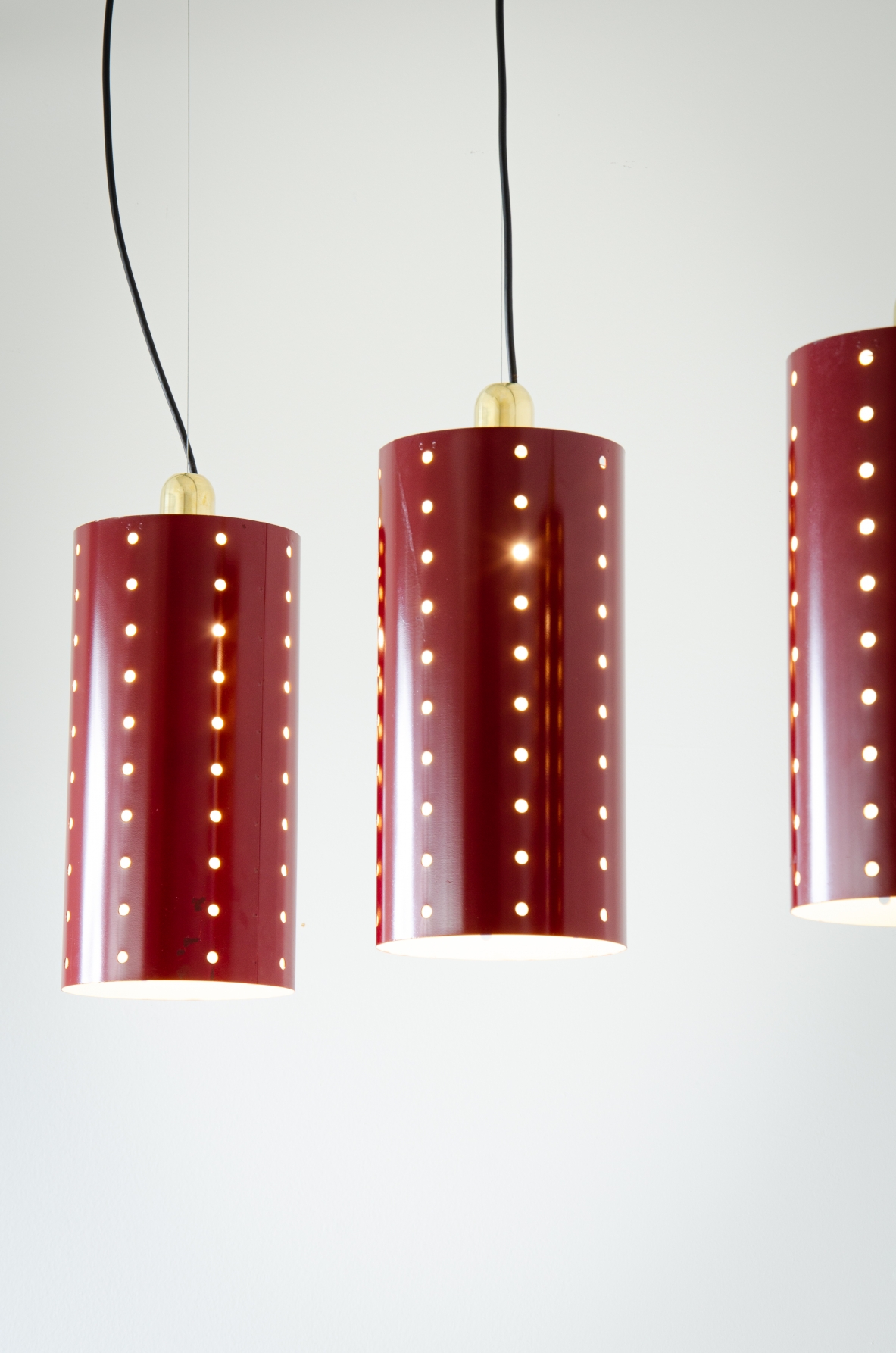 Quattro lampade a cilindro in metallo laccato e forato con bicchiere in ottone.  Manifattura italiana 1960ca.