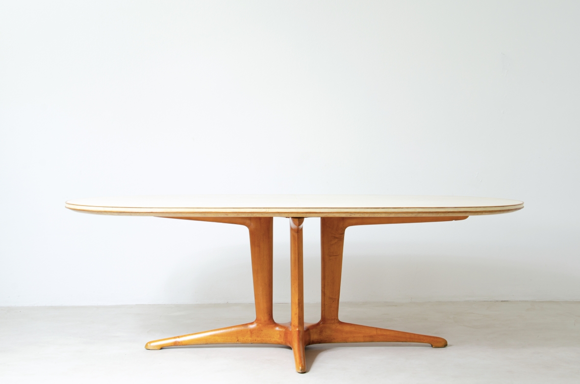 Grande tavolo con elegante struttura in legno biondo e piano rivestito in pergamena.  Manifattura italiana anni 50.