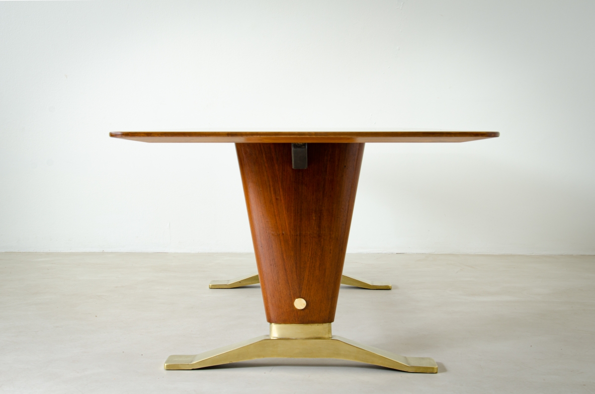Grande tavolo in legno di noce con due montanti tenuti da traversa in ottone e importanti basamenti in fusione di bronzo.  Manifattura italiana 1940ca.