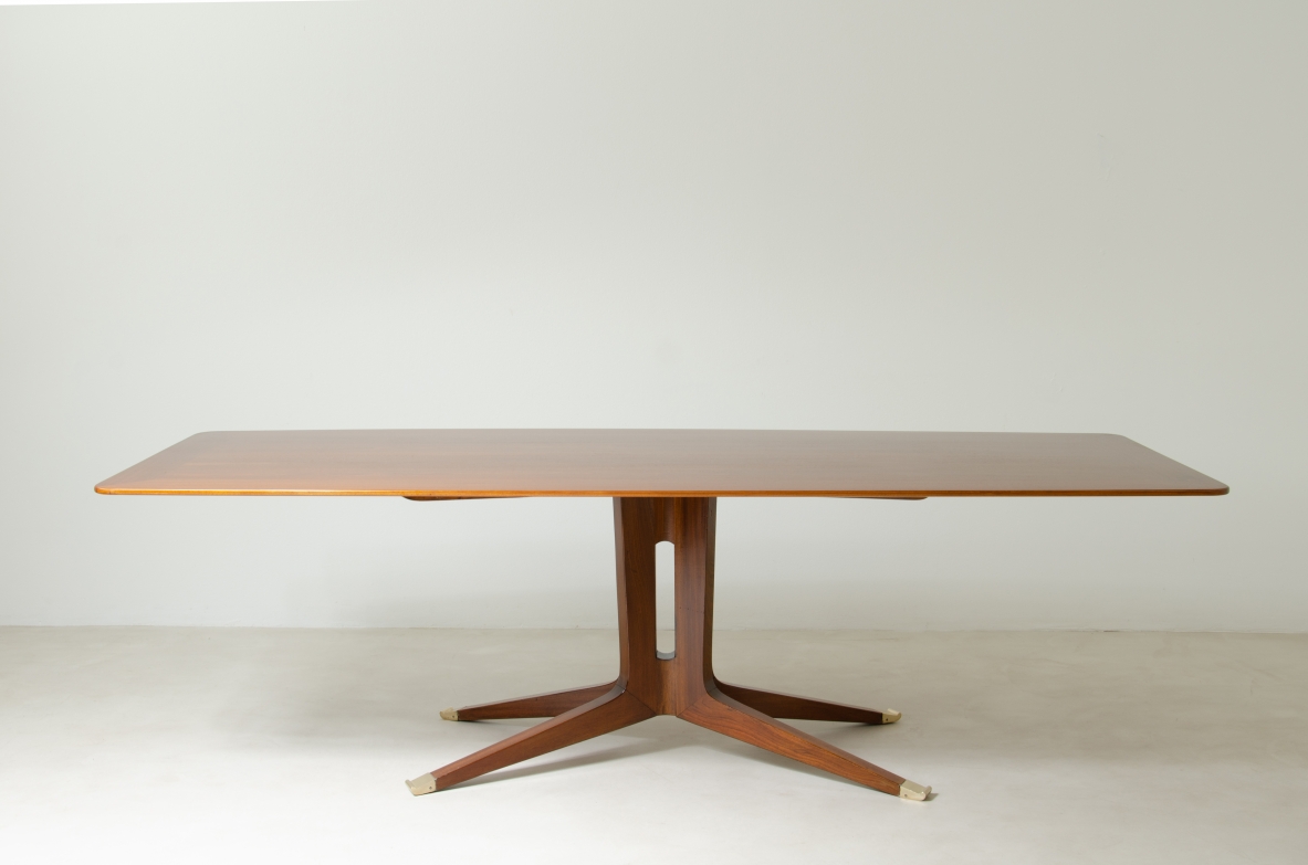 Large mahogany table with shaped top and leg with central stem and four spokes with elegant brass tip.  1950's Italian manufacture.