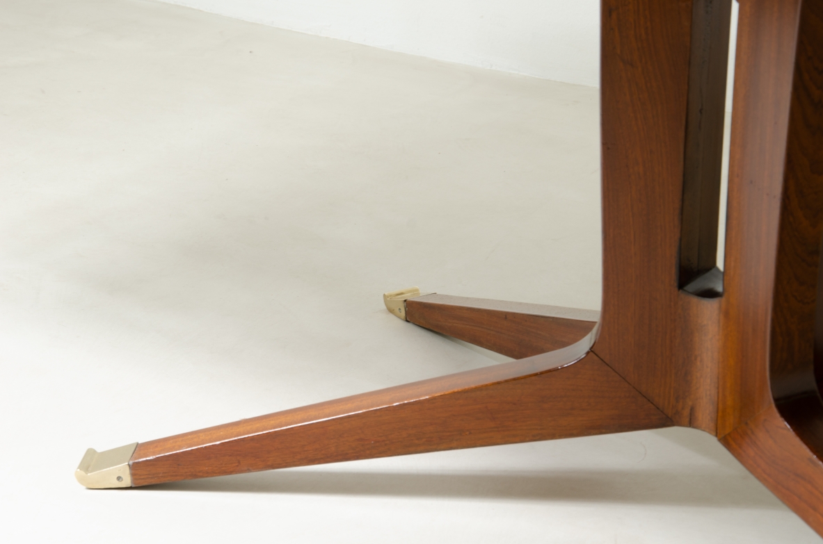 Large mahogany table with shaped top and leg with central stem and four spokes with elegant brass tip.  1950's Italian manufacture.