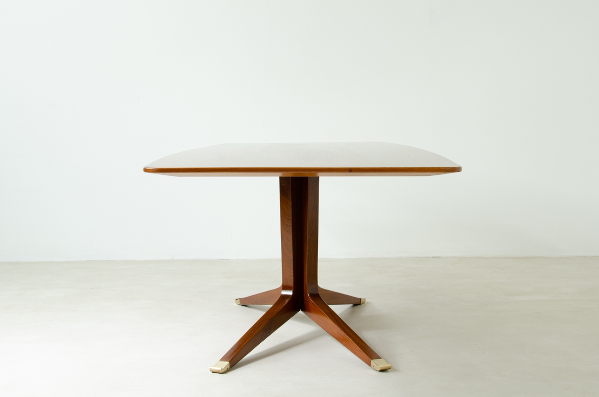 Large mahogany table with shaped top and leg with central stem and four spokes with elegant brass tip.  1950's Italian manufacture.