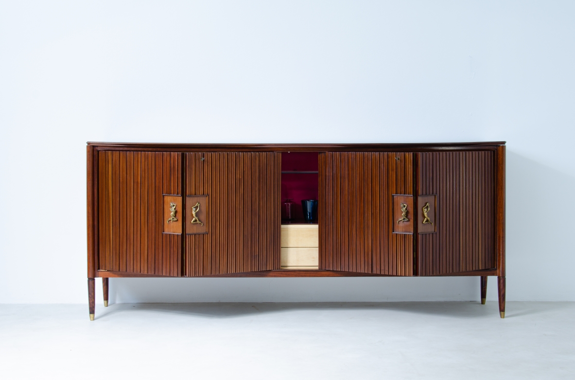 A large 1950's sideboard designed by Osvaldo Borsani for Arredamenti Borsani Varedo. Grinded mahogany, gilded bronze handles by Lucio Fontana, interior illumination.