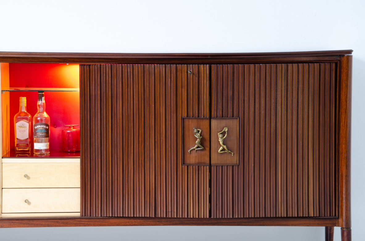 A large 1950's sideboard designed by Osvaldo Borsani for Arredamenti Borsani Varedo. Grinded mahogany, gilded bronze handles by Lucio Fontana, interior illumination.