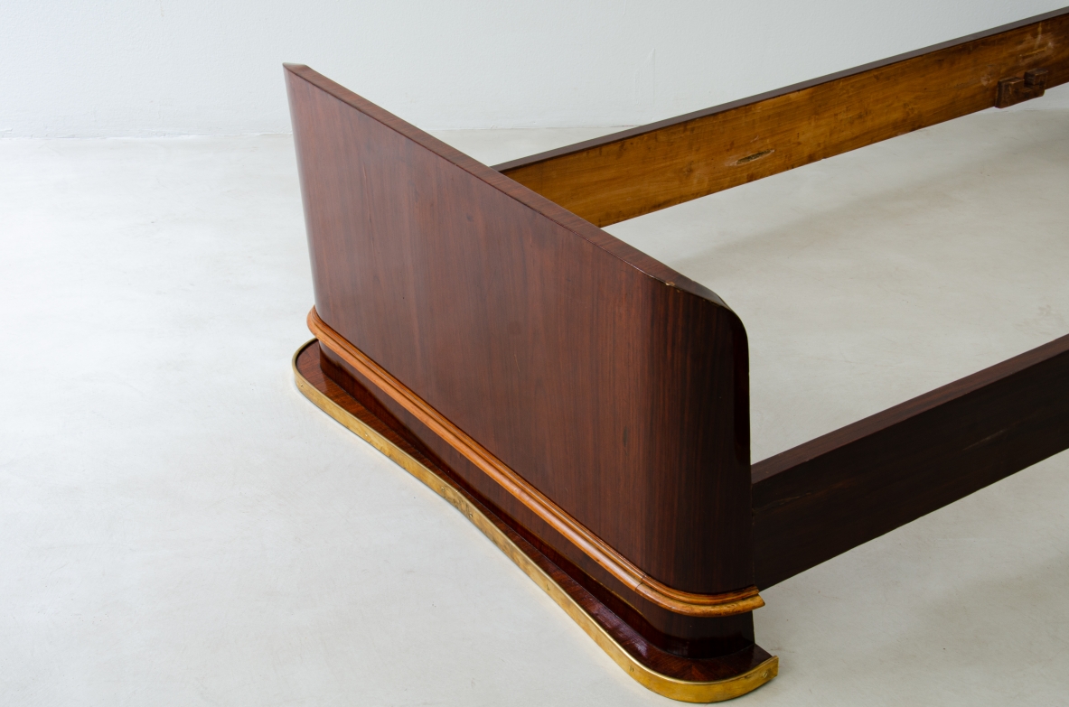 Pair of elegant rosewood beds with blond maple profiles and parchment headboard, brass details.  Italian manufacture, 1940's.