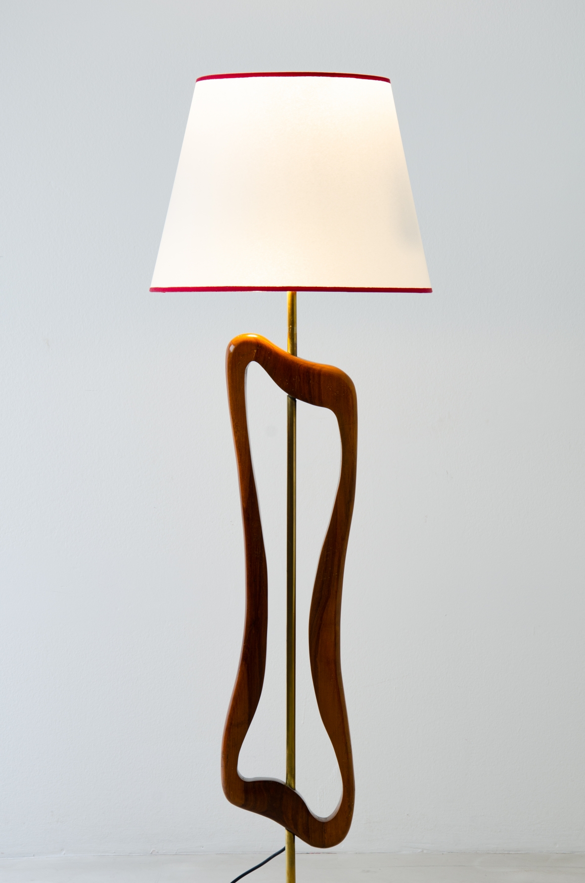 Unique three-light sculptural floor lamp in brass and shaped wood with parchment shade. Italian manufacture, 1950's.
