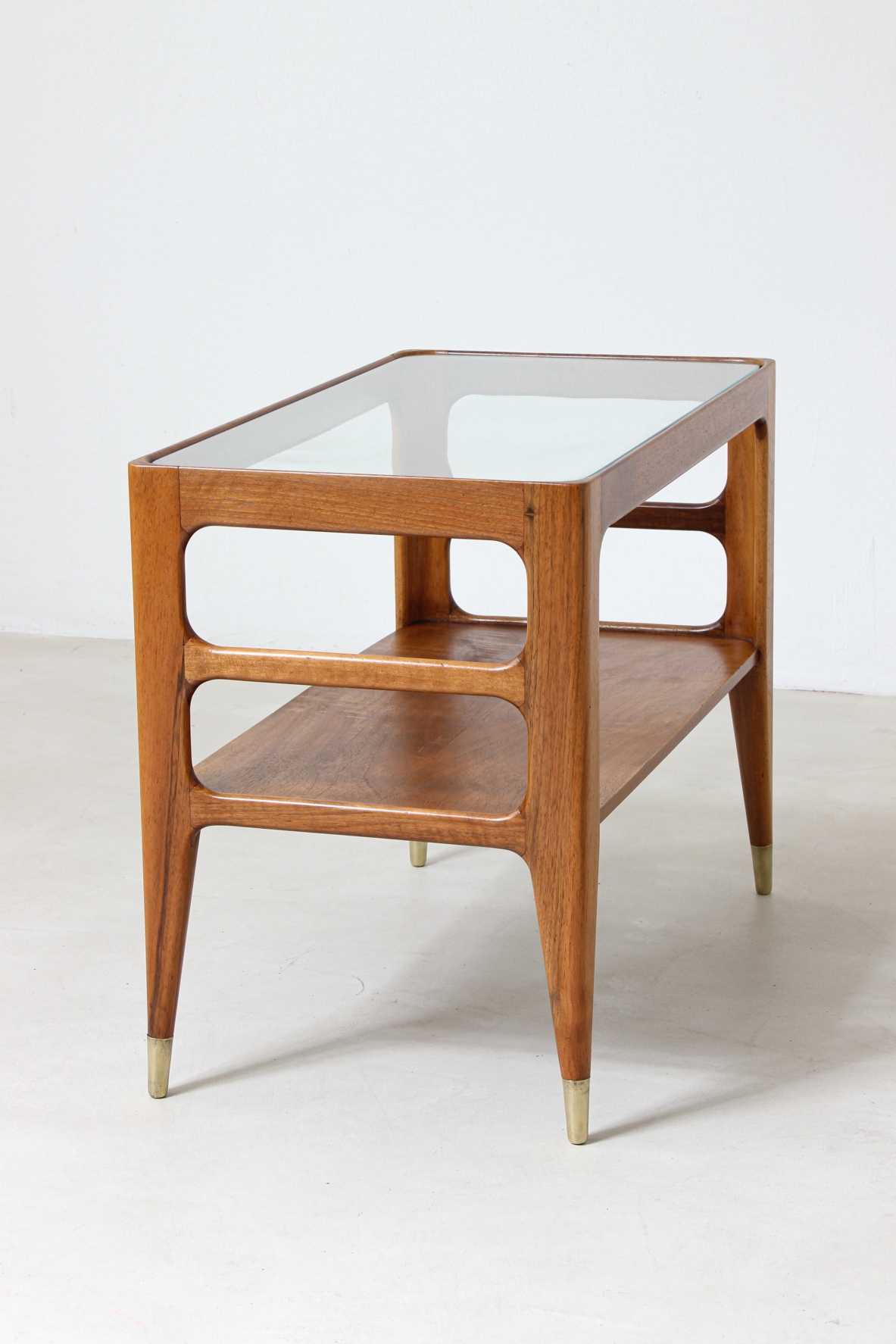 Unique pair of center tables in walnut with crystal glass top and sides openings, nice brass tips.  Attributed to Gio Ponti 1950's