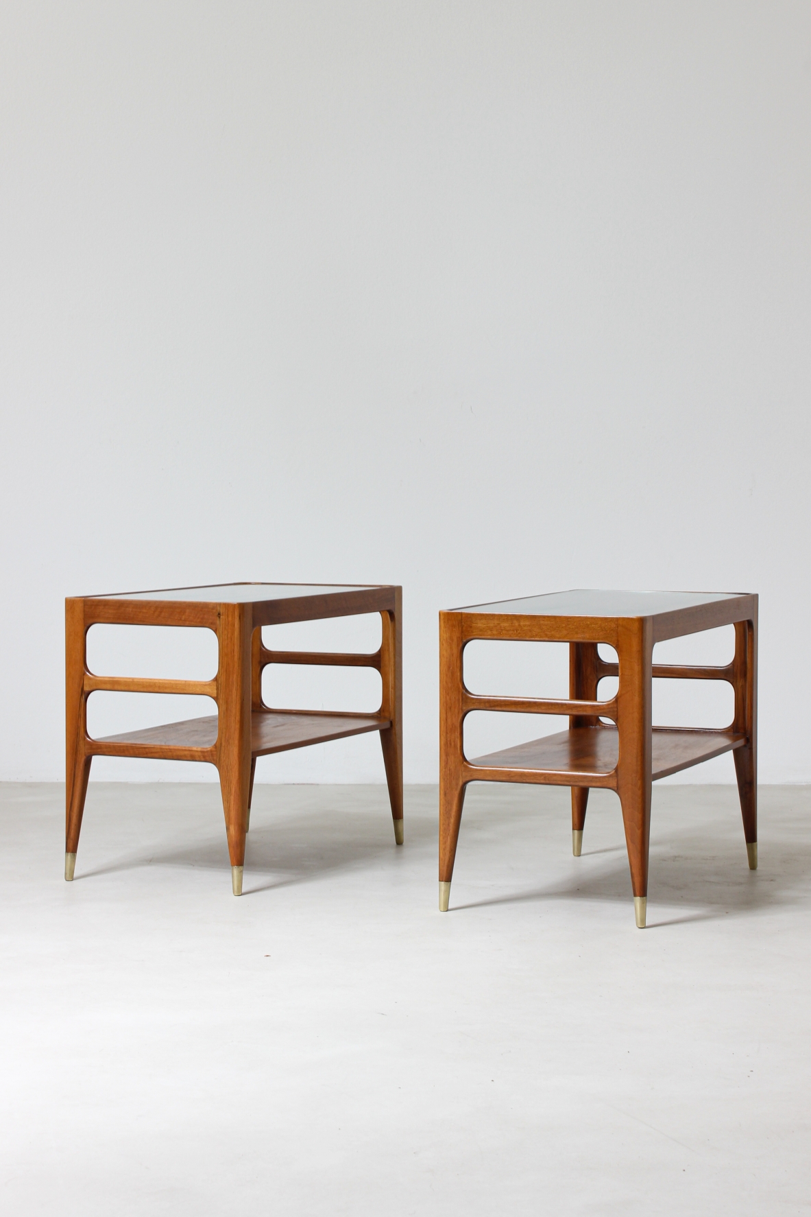 Unique pair of center tables in walnut with crystal glass top and sides openings, nice brass tips.  Attributed to Gio Ponti 1950's