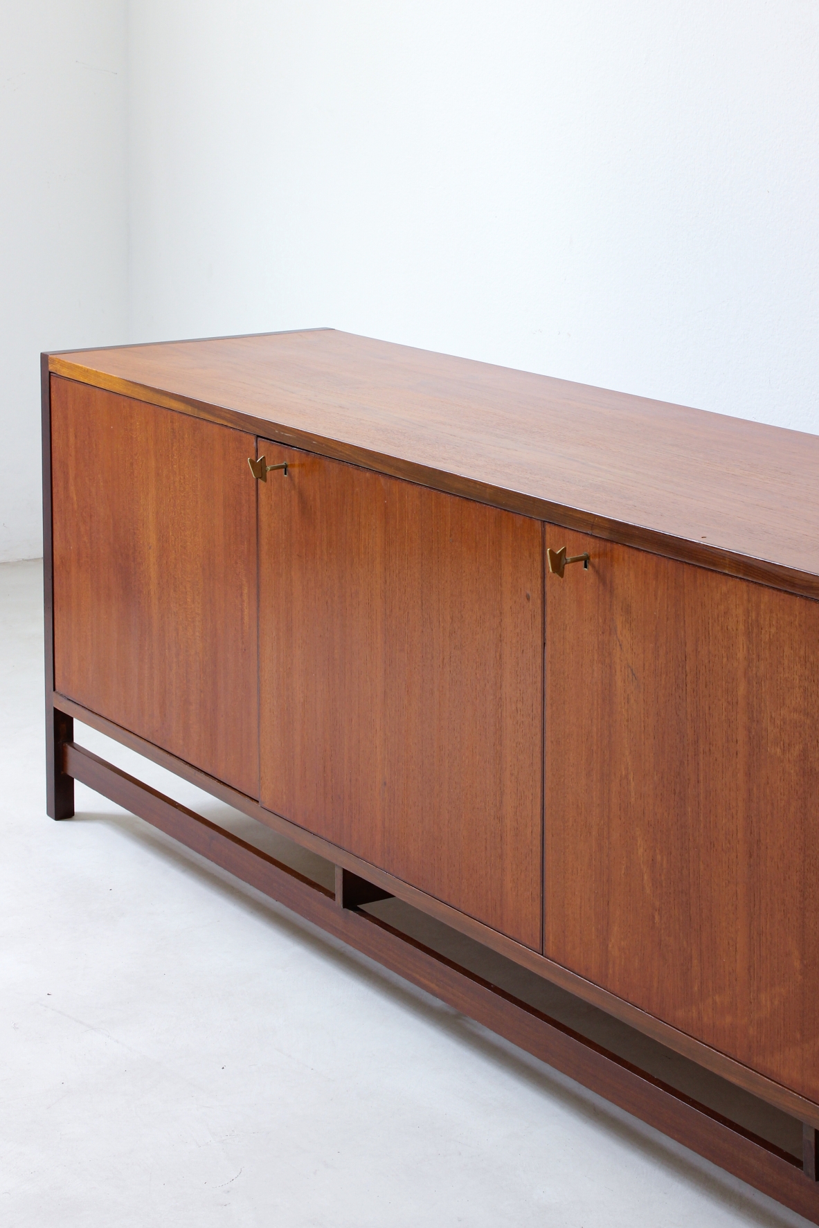Sideboard in blond wood with three doors and drawers on one side.  Italian manufacture,1960s.
