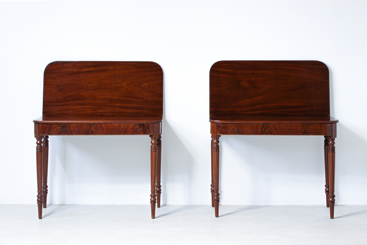 Pair of elegant consoles in mahogany with double book top and turned legs.