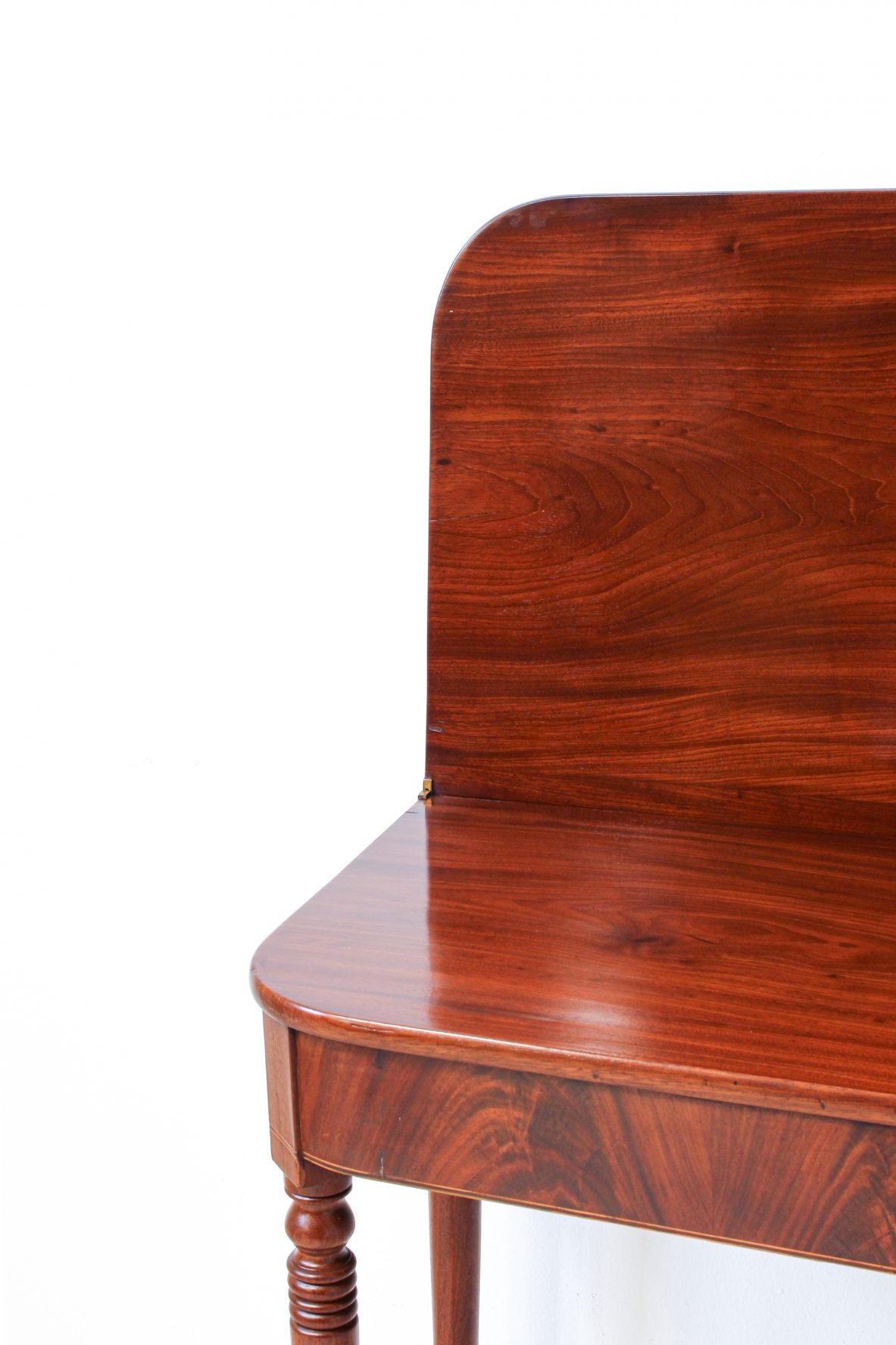 Pair of elegant consoles in mahogany with double book top and turned legs.