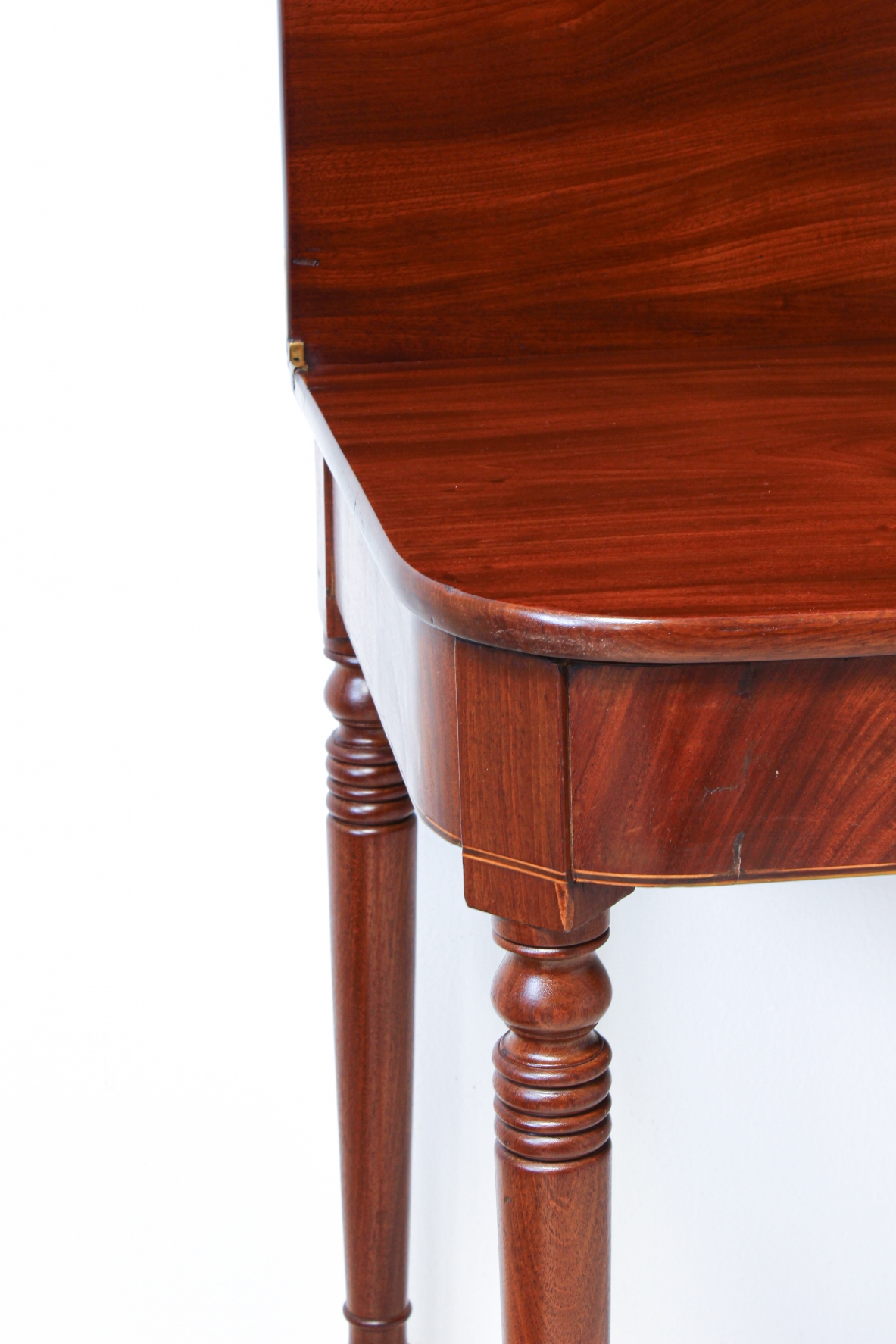 Pair of elegant consoles in mahogany with double book top and turned legs.