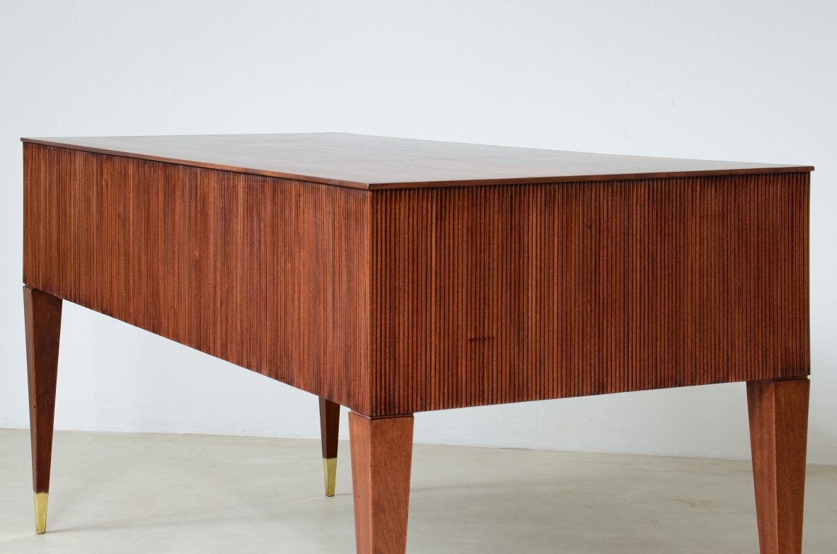 Mahogany desk with 4 drawers, front and sides in grissinato wood, legs with elegant brass tips.  1950s Italian manufacture.