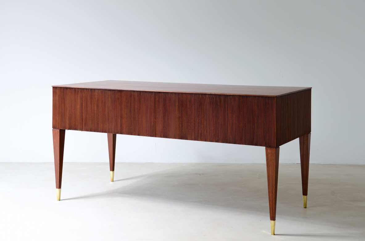 Mahogany desk with 4 drawers, front and sides in grissinato wood, legs with elegant brass tips.  1950s Italian manufacture.