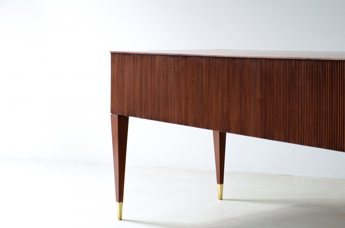Mahogany desk with 4 drawers, front and sides in grissinato wood, legs with elegant brass tips.  1950s Italian manufacture.
