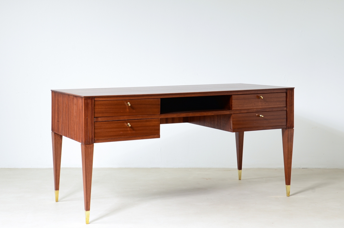 Mahogany desk with 4 drawers, front and sides in grissinato wood, legs with elegant brass tips.  1950s Italian manufacture.