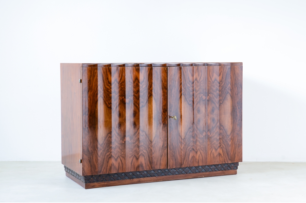 Borsani Varedo  Unique chest of drawers made of a very high quality with 4 drawers hidden by two doors with grooves that continue on the top forming a shell design.