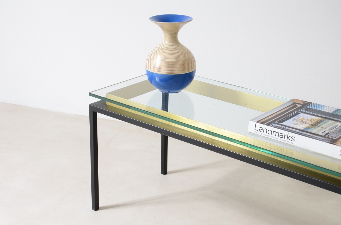 Low table with metal structure, brass riser and thick cut glass top.  Italian manufacture around 1960.