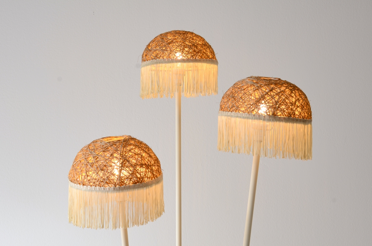 Three-arm floor lamp in painted metal with rattan shades and fabric fringes, Italian manufacture 1950's