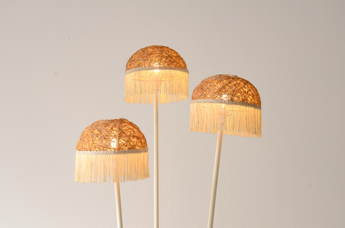 Three-arm floor lamp in painted metal with rattan shades and fabric fringes, Italian manufacture 1950's