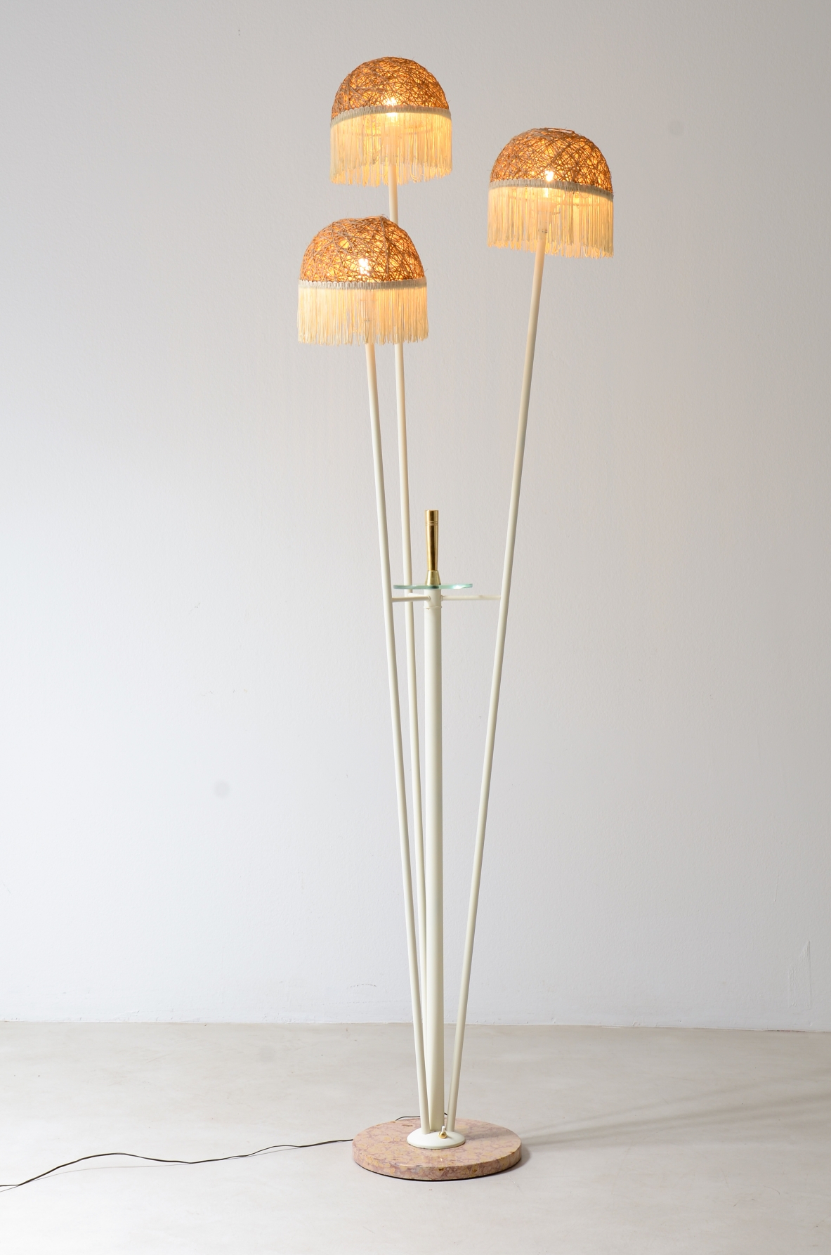 Three-arm floor lamp in painted metal with rattan shades and fabric fringes, Italian manufacture 1950's