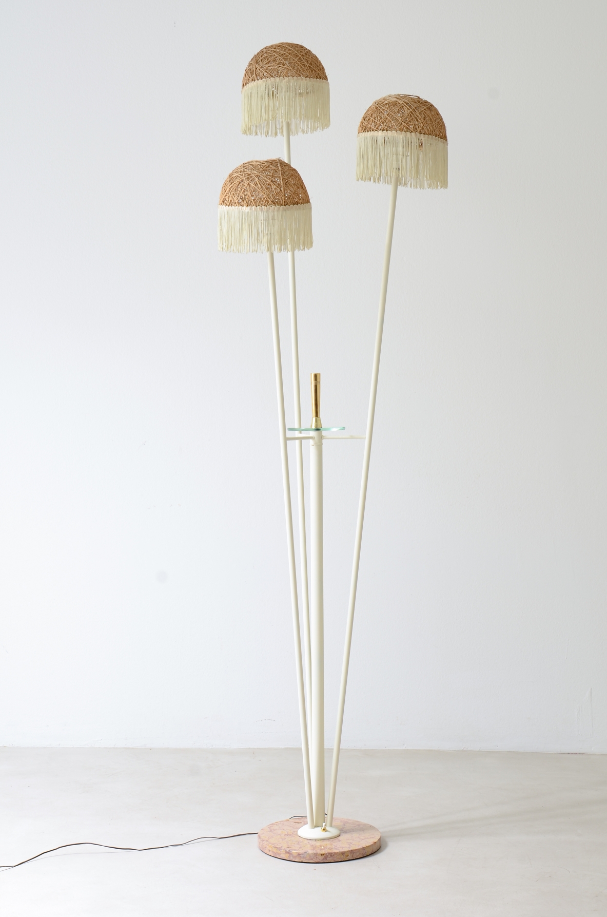 Three-arm floor lamp in painted metal with rattan shades and fabric fringes, Italian manufacture 1950's