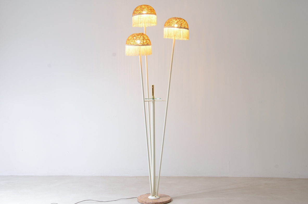 Three-arm floor lamp in painted metal with rattan shades and fabric fringes, Italian manufacture 1950's