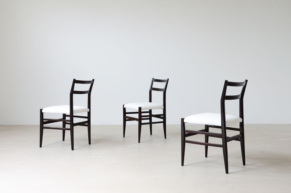 Gio Ponti  Set of 12 chairs in black stained wood with fabric covering.  Modello leggera,  Cassina manufacture 1954.