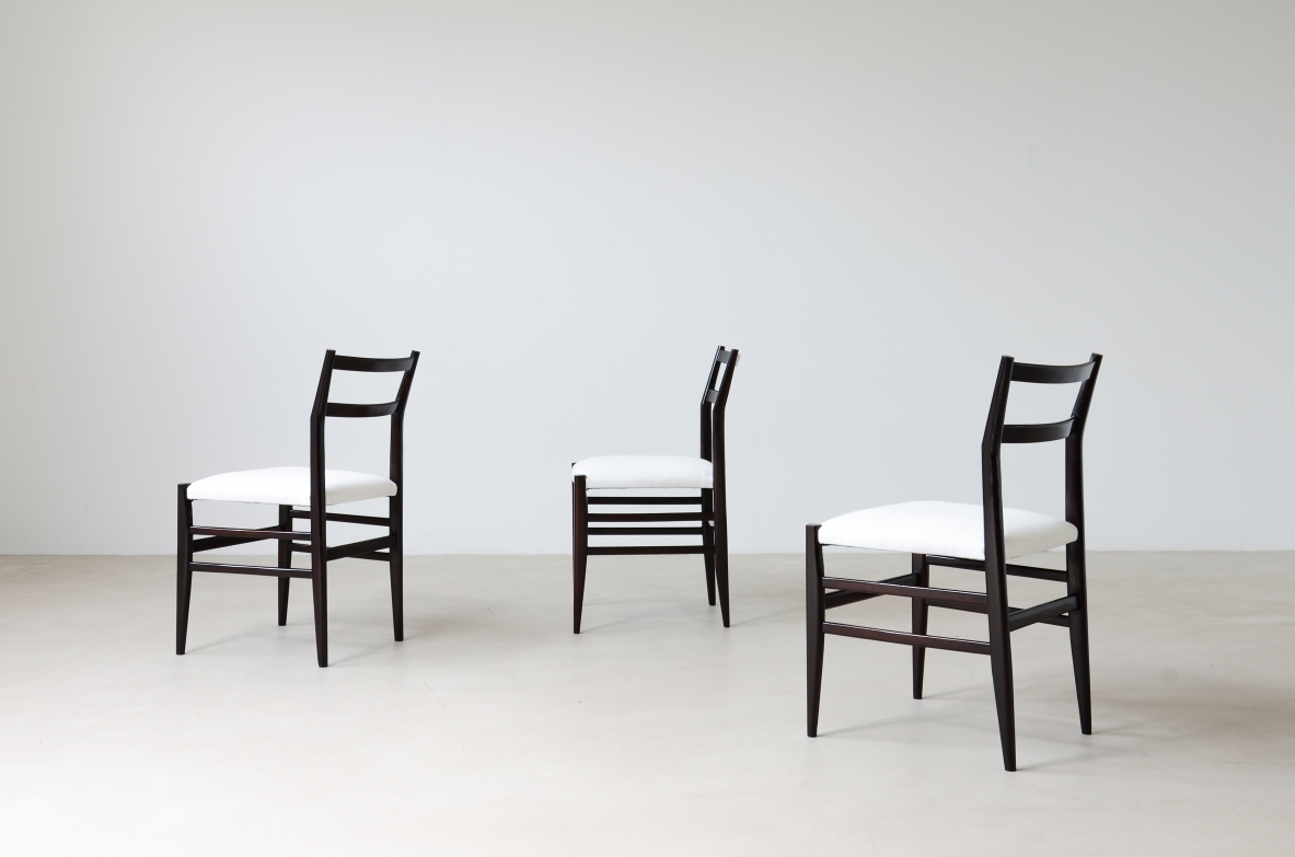 Gio Ponti  Set of 12 chairs in black stained wood with fabric covering.  Modello leggera,  Cassina manufacture 1954.