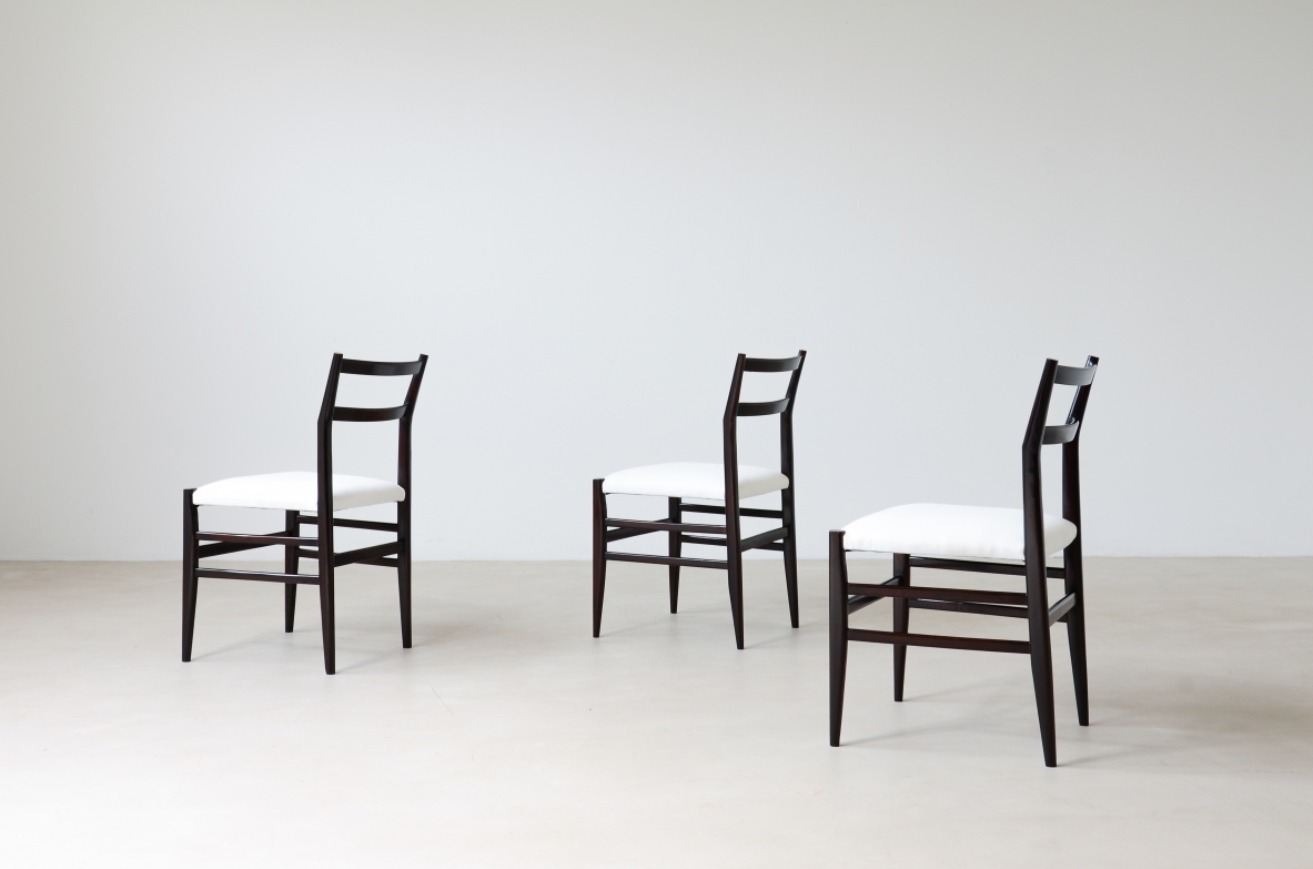Gio Ponti  Set of 12 chairs in black stained wood with fabric covering.  Modello leggera,  Cassina manufacture 1954.