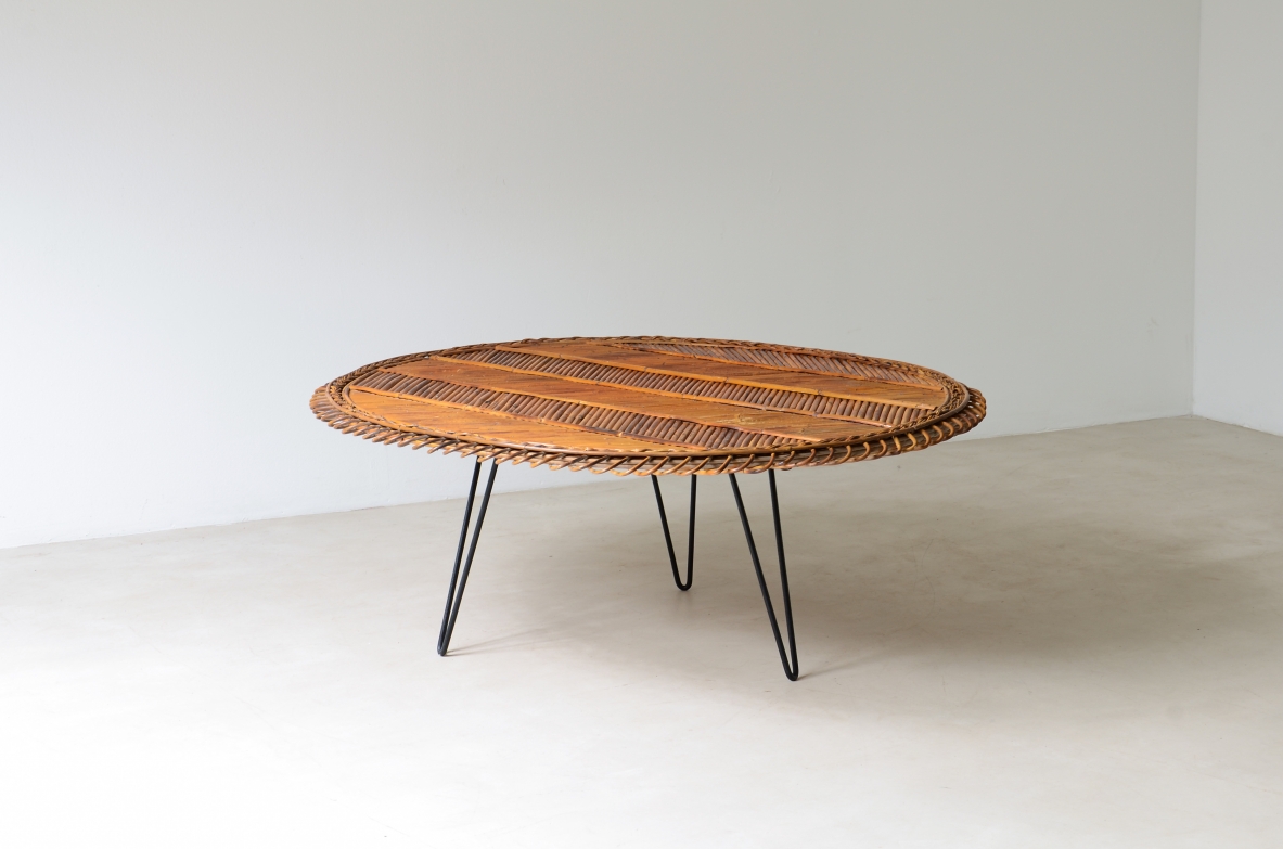 Large low table with herringbone rattan top and curved iron leg. 60's