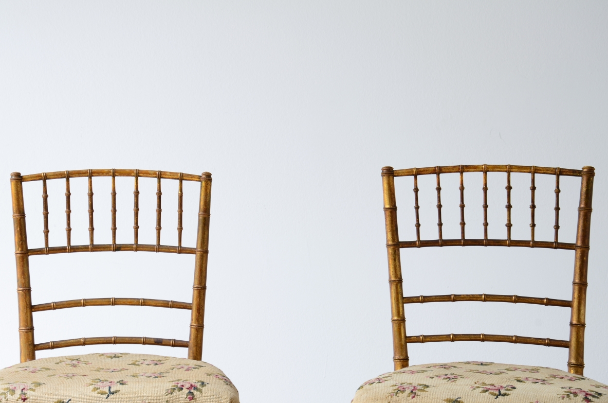 Pair of chairs in turned and gilded wood with upholstered seat 