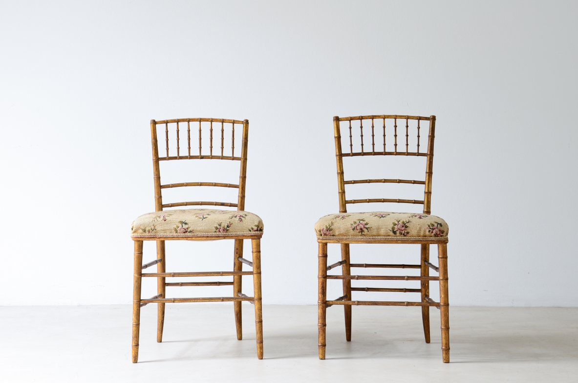 Pair of chairs in turned and gilded wood with upholstered seat 