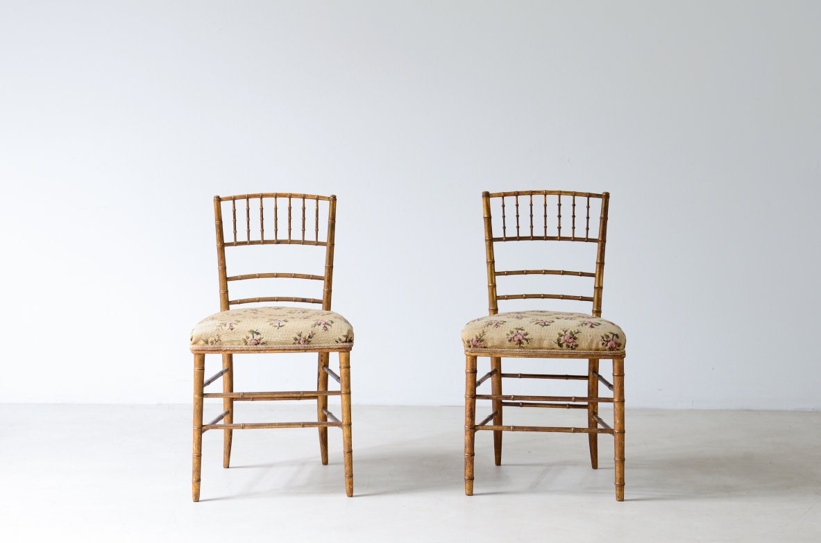 Pair of chairs in turned and gilded wood with upholstered seat 