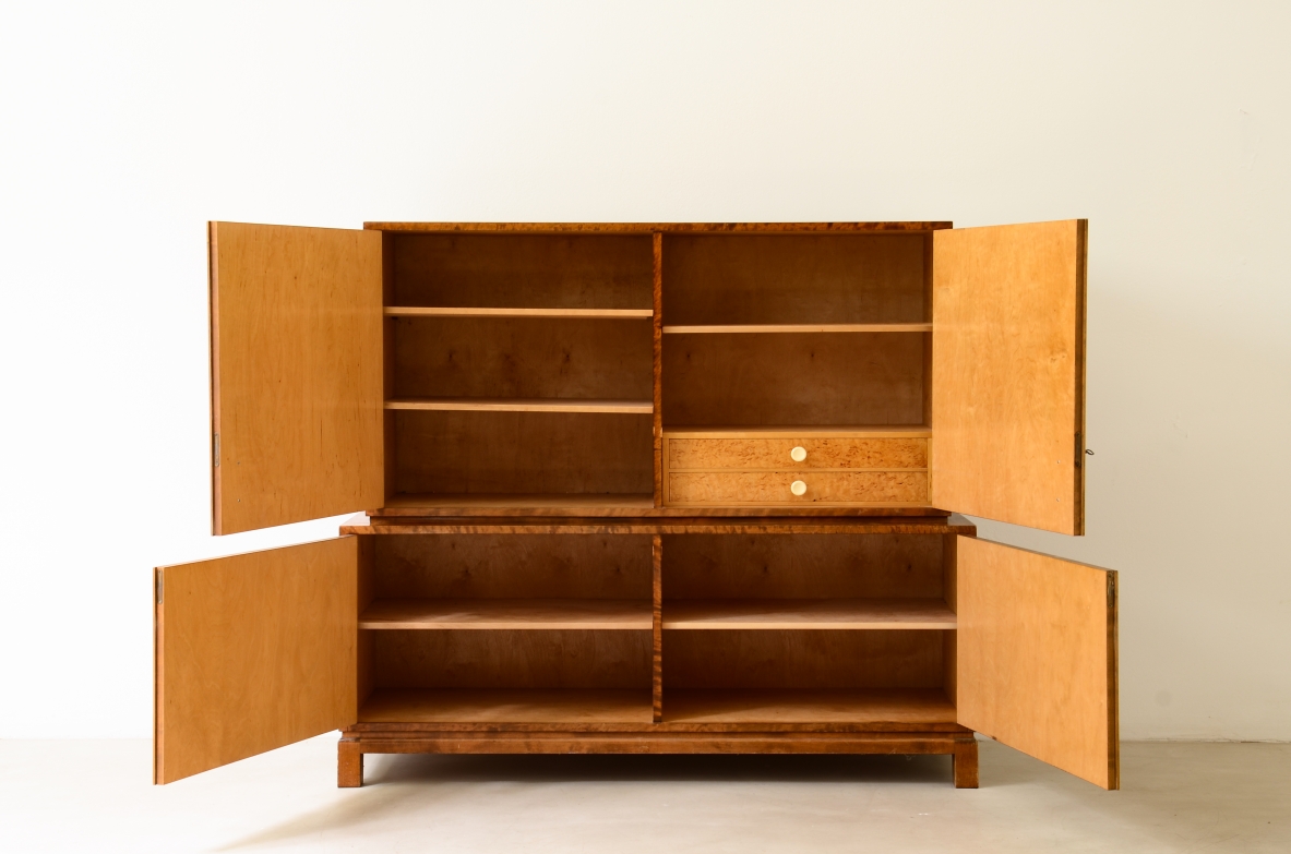 Storage unit in the style of Axel Einar Hjort, in flamed maple with Art Deco inlays on the front.Sweden  approx. 1930