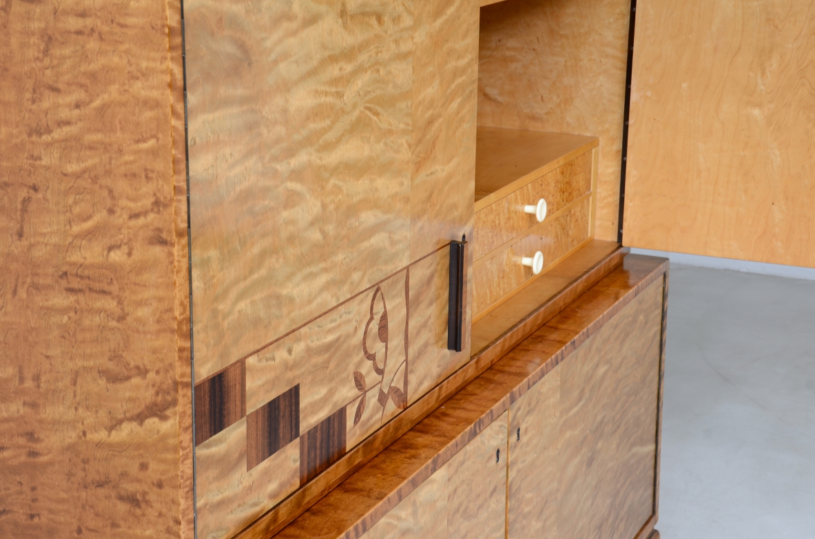 Storage unit in the style of Axel Einar Hjort, in flamed maple with Art Deco inlays on the front.  Sweden  approx. 1930