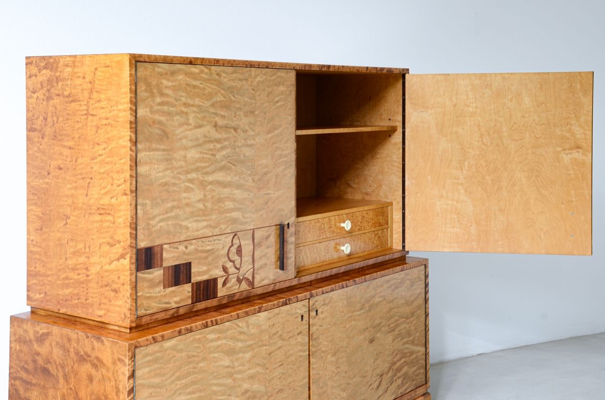 Storage unit in the style of Axel Einar Hjort, in flamed maple with Art Deco inlays on the front.  Sweden  approx. 1930