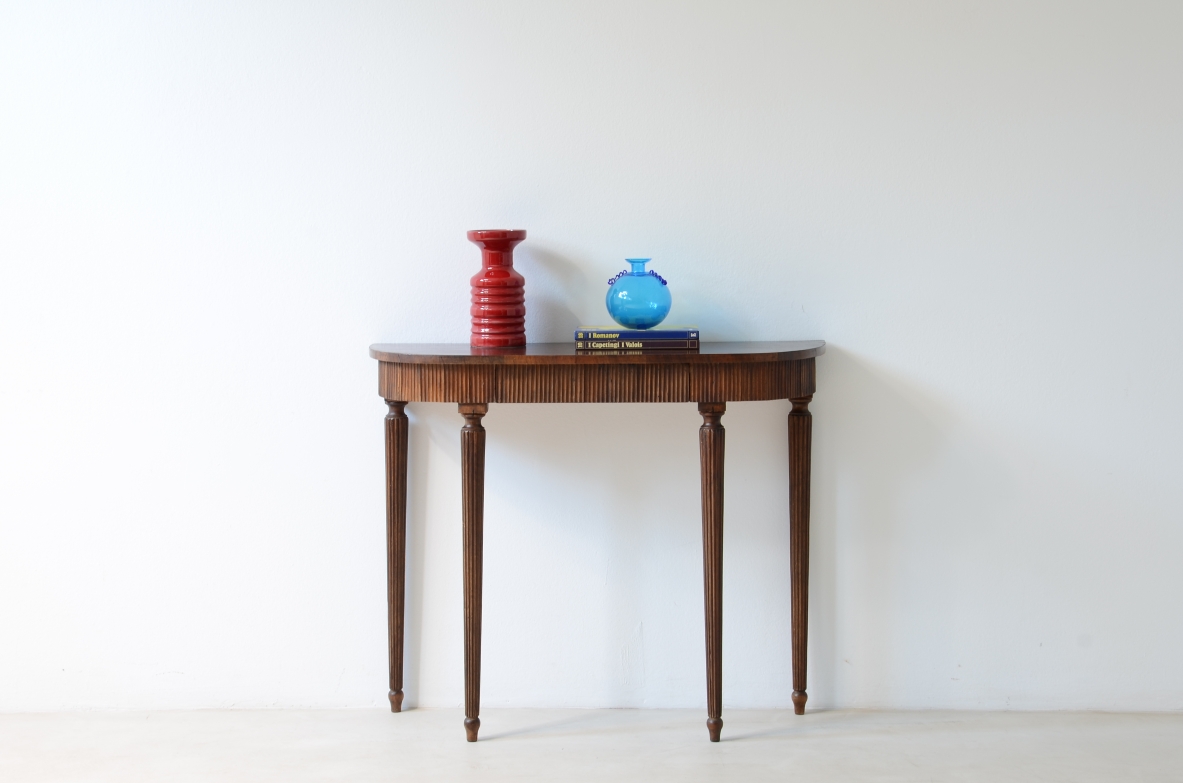 Piccola console in noce con piano curvato e fascia in legno cannettato.Manifattura italiana 1940ca.