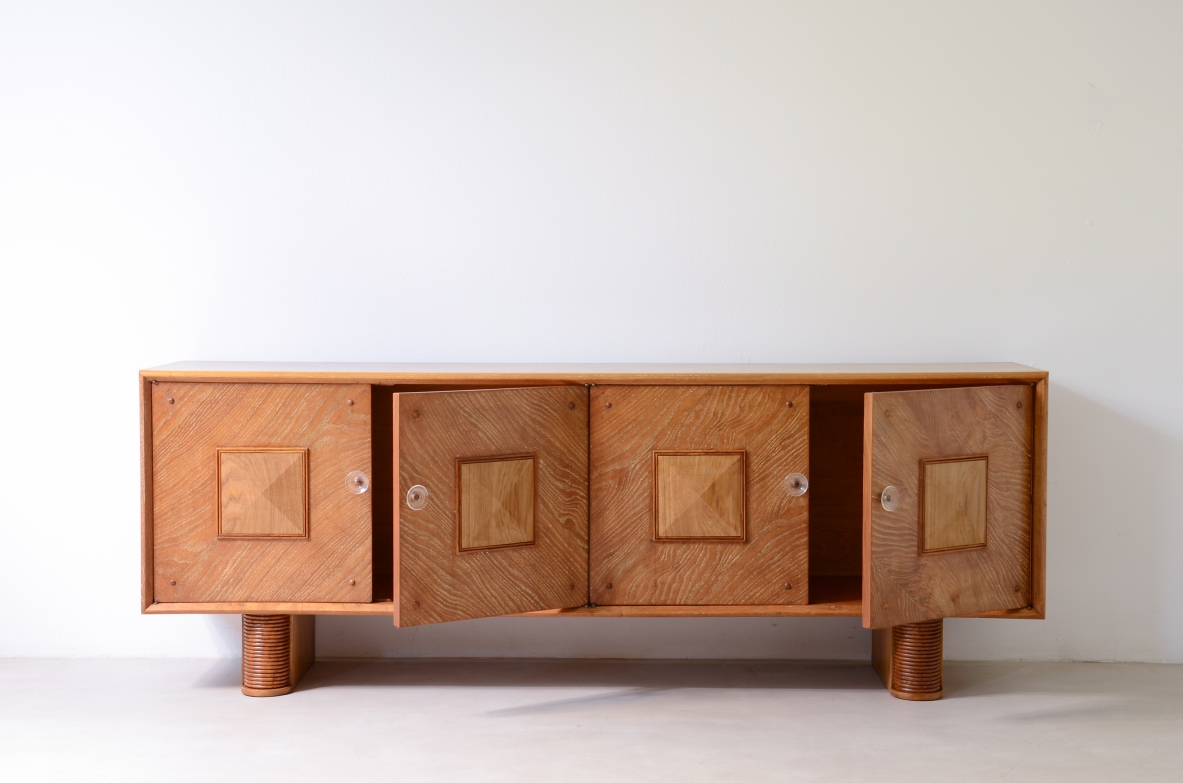 Large 4-door oak cabinet with central diamond decorative motif and curved wood bases, 1940.